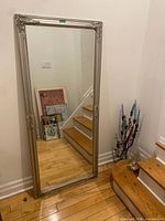 Front view of tall silver framed mirror
