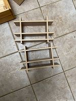 Two small wood wall shelves on tile floor