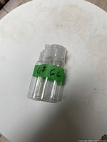 three clear plastic bottles banded together front view