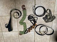 All six belts laid out on floor