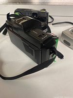 SRZ 500 WR-1 camera side view, showing strap and top controls