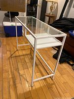 Full view of desk showing glass top and metal frame