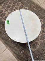 Top view showing circular white tabletop with ruler indicating diameter
