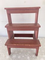 Front view of wooden 3-tier shelf showing all tiers