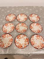 overview of nine matching floral plates