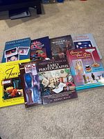 All eight reference books laid out on carpet showing covers