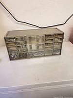 Front view of 18-drawer organizer showing mixed fasteners in drawers