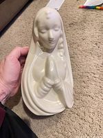 Front view of white ceramic praying Madonna planter