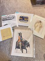 All six paper items laid out on carpet