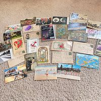 Overview of entire spread of vintage postcards on carpet