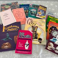 All twelve pottery reference books arranged on table