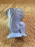 Front view of blue cornucopia vase showing shape and glaze