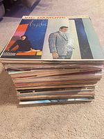 Stack of vinyl records, top album Vic Damone "Angela"