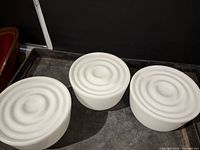 three white glass shades top view showing concentric ring pattern