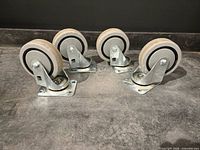 Four swivel caster wheels arranged on surface showing full view
