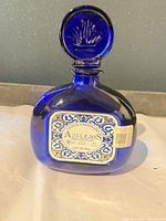 Front of cobalt blue Azulejos tequila bottle with stopper and label visible