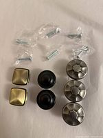 Front view of all seven knobs with screws