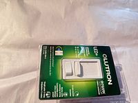 Front of sealed package showing Lutron Skylark Contour CTCL-153P dimmer