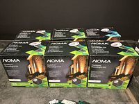 Front view of six Noma Outdoor Floodlight Kit boxes