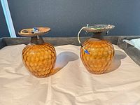 Pair of amber glass sconces side view showing mounting plates and wiring