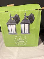 Front of box showing pair of black outdoor wall lanterns
