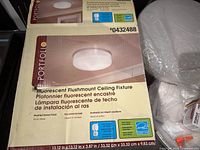 Front of boxed Portfolio flushmount ceiling fixture showing model and specs