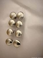 Front view of eight silver metal cabinet knobs