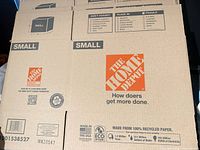 Front panels of flattened The Home Depot small boxes showing logo and size designation