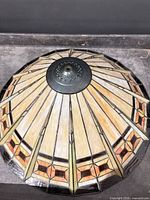 Top view of dome plastic Tiffany-style lamp shade showing panel pattern and metal fitter