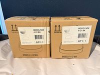 Front view of two sealed Trans Globe boxes showing model number 4121BK and quantity 1 per box