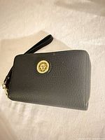 Front view showing gold Anne Klein medallion and texture