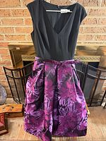 Front view of Eliza J purple floral dress hanging