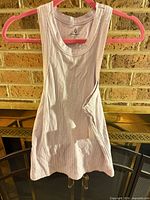 Front view of ribbed pink tank top hanging on hanger