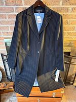 Full view of blazer on hanger showing length, pinstripe pattern, and overall condition