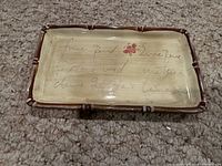 Top view of ceramic tray showing surface design, bamboo-look rim and flower decal