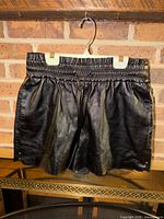 Full view of black leather shorts hanging