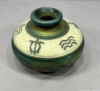 Top and side view of signed raku vase showing crackle glaze and glyphs