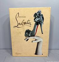 Front cover featuring stylized shoe and Christian Louboutin title