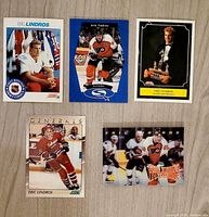 Five Eric Lindros hockey cards arranged on surface