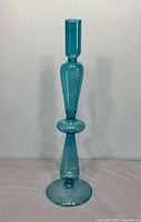 Full view of teal blown-glass candlestick holder