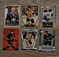 All six Jack Eichel Upper Deck hockey cards displayed front side on wood surface