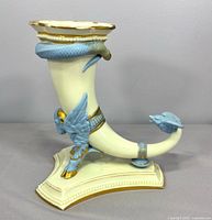 Left-front view showing winged ram head, snake, bird and gilded accents