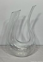 Front view of clear swan-shaped decanter