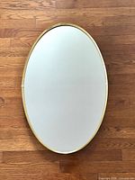 Front view of oval mirror in portrait orientation