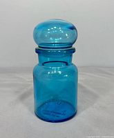 Full view of blue glass jar with lid
