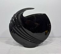 front view of glossy black ribbed ceramic vase