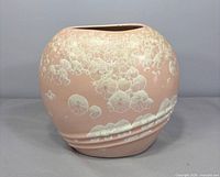 Front view of pink crystalline glazed ceramic vase showing overall shape and glaze pattern