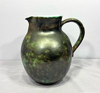 Full front view of mottled green ceramic pitcher-style vase