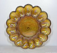 Front view of marigold carnival glass deviled egg tray