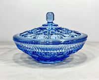 Side view of blue pressed glass candy dish with lid attached